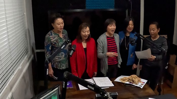 Singing-the-ladies The Arcadia High School Chinese Parent's Choir in studio with Christine Zito singing on Arcadia FYI.