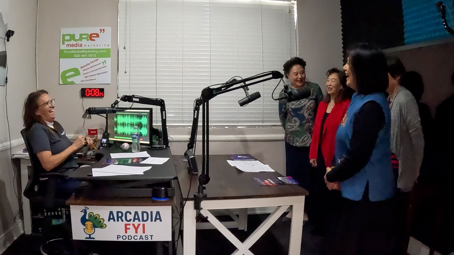 The Arcadia High School Chinese Parent's Choir laughing with Christine Zito on Arcadia FYI.